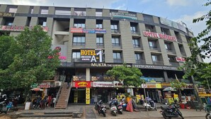 A multi-story building with various commercial establishments including a hotel, spa, and restaurant. - hotel A-one (Gandhinagar)