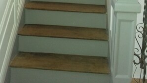 A staircase with wooden steps and white railings. - The beach at the end of the street (Treffiagat)