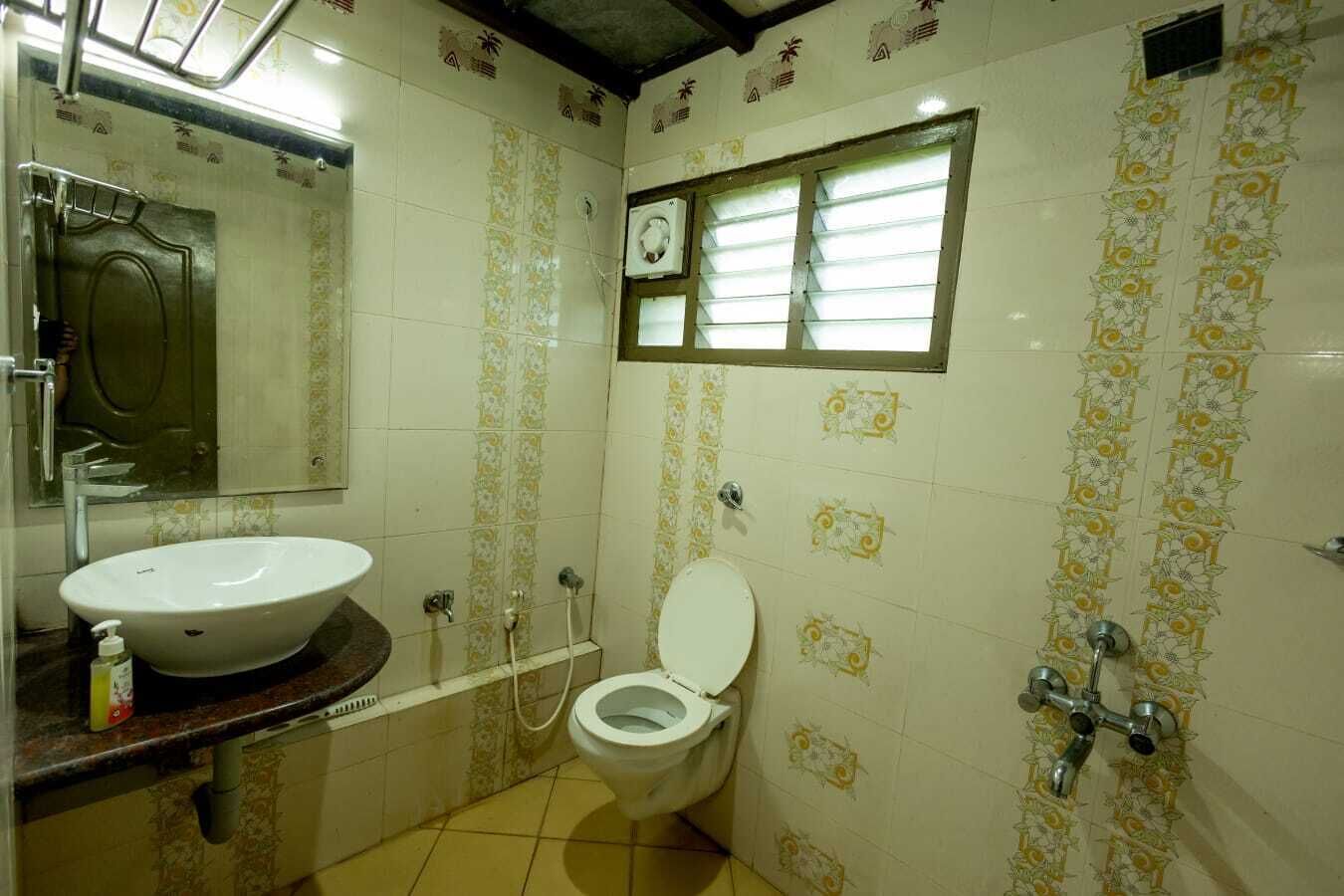 A bathroom with a sink, toilet, and shower.