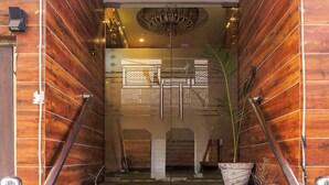 A wooden staircase with potted plants at the bottom. -  Hotel RK Residency Opposite ISBT Sector 43 Chandigarh (Chandigarh)