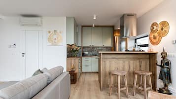 Deluxe Suite, 2 Bedrooms, Hill View | Living area | Flat-screen TV