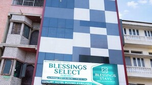 A multi-story building with a sign for 'Blessings Select' indicating luxury hotel rooms available. - BLESSINGS SELECT PERIAMET (Chennai)