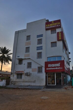 A multi-story building with signage for 'Sampath Residency A/c' and 'Mithra Lodge.' - Sampath Residency (Palani)