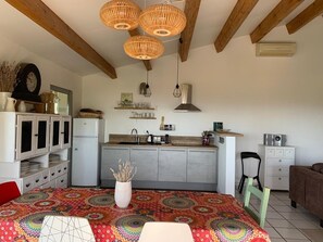 A compact kitchen with a central island, wooden beams, and pendant lighting. - 3-Bedroom House with Private Pool and Sea View (La Croix-Valmer)