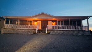 A two-story house with a porch and a garage. - Rathbun Lake, 1.5 miles from the Lake, 2-bdrm, 2 bath sleeps 7 in Rathbun, Iowa (Rathbun)
