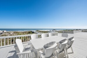 A white deck with a table and chairs overlooking the beach. - Seaside Splendor, The pinnacle of luxury. Brand New Oceanfront Rental (Saint Augustine)