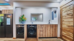 Eine kompakte Küche mit eingebauten Geräten, Holzschränken und einem dekorativen Spiegel.