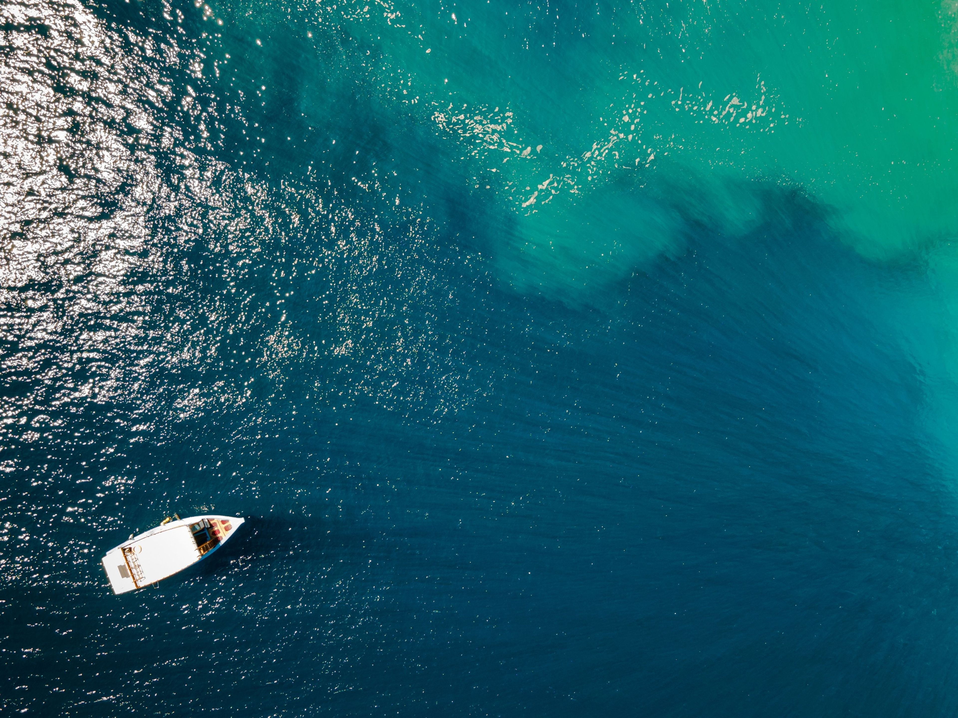 A boat on a body of water with a clear sky above.