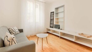 A modern living room with a grey sofa, a small white table, and a built-in TV shelf. - Welcome to Casa del Sale, a comfortable holiday apartment located right in the center of La Spezia – the perfect base to explore the wonders of the Cinque Terre and the Gulf of Poets.The apartment is cozy, well-kept, and equipped with everything you ne (La Spezia)