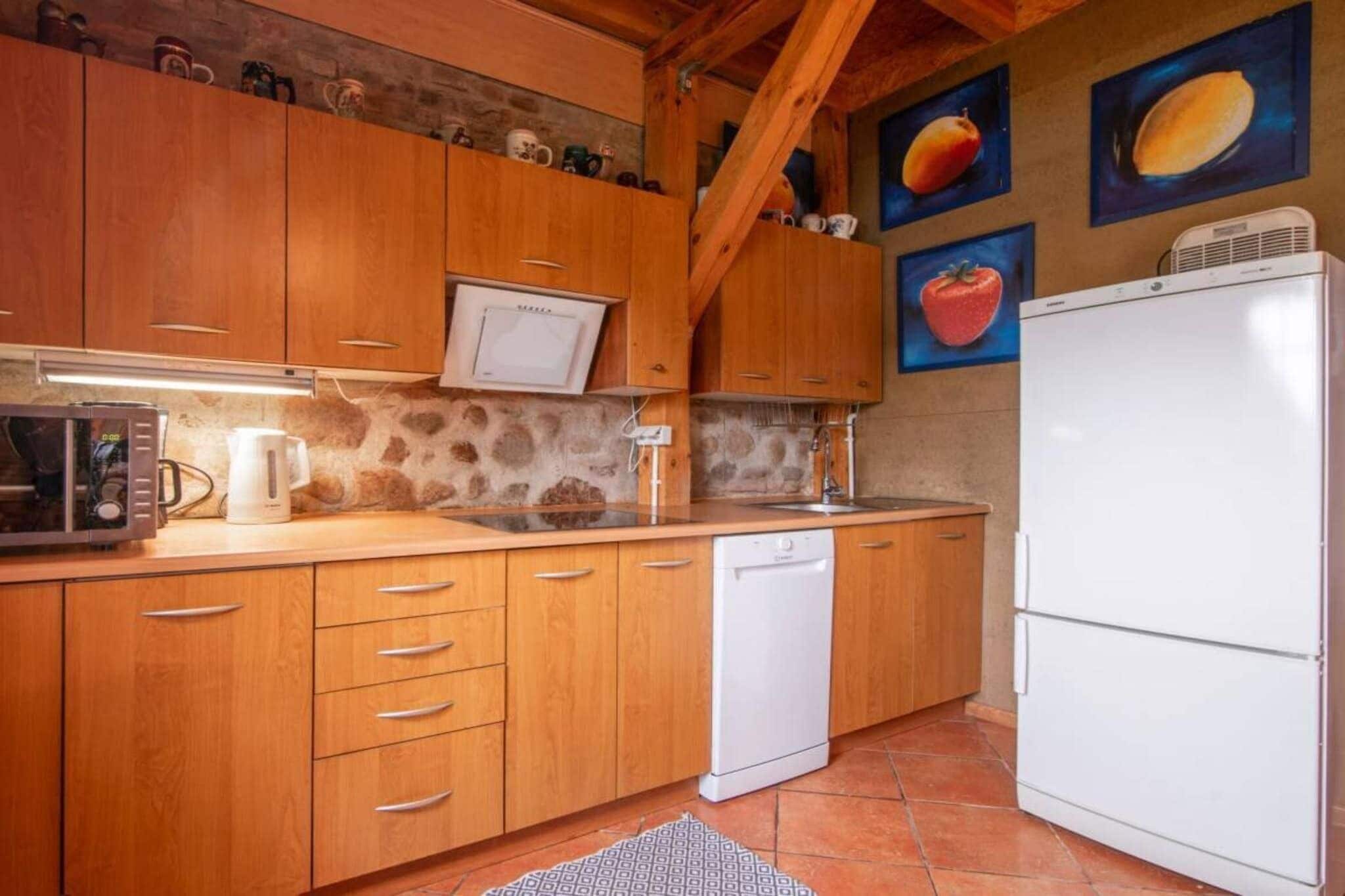 A kitchen with wooden cabinets, a microwave, a dishwasher, and a refrigerator.