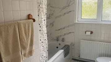 Shower, hair dryer, towels, toilet paper
