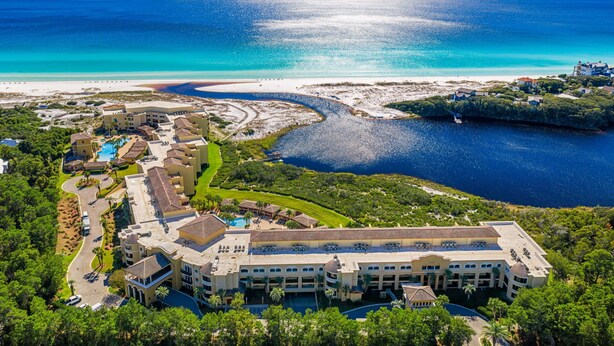 An aerial view of a resort with multiple buildings, a swimming pool, and a beach area. - 5 Bedroom • 4.5 Bath • Sleeps 10 • Gulf-Front • Includes 1 Complimentary Beach S (Santa Rosa Beach)