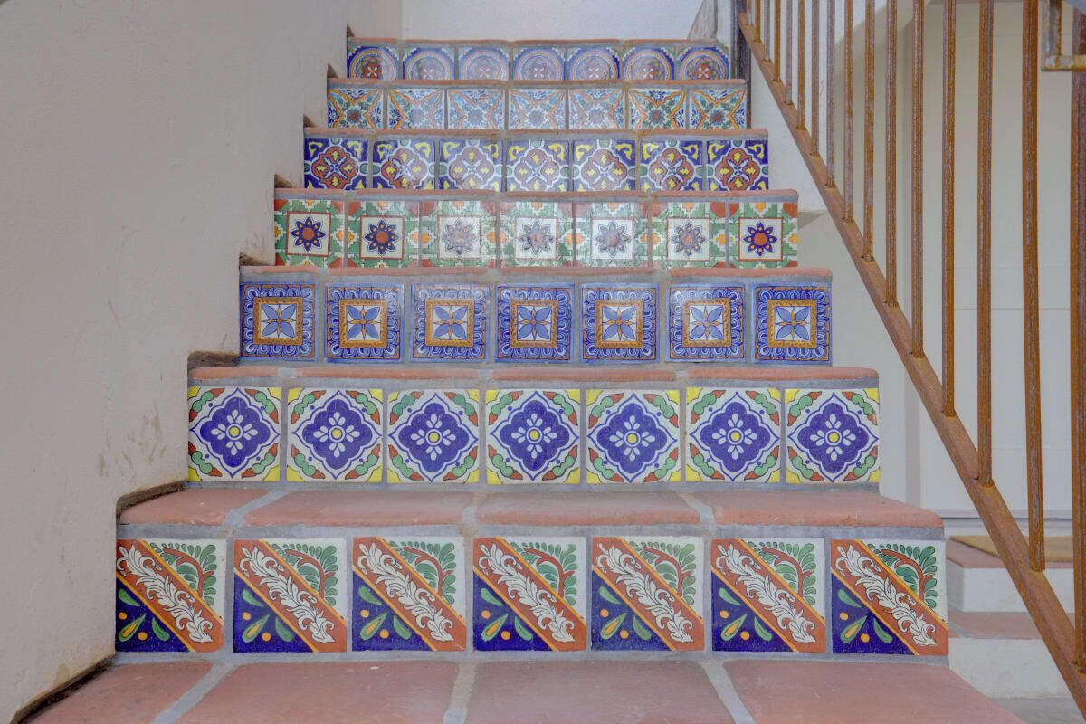 A staircase with colorful, patterned tiles.