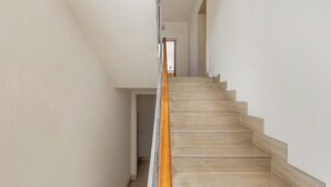 A staircase with wooden steps and a wooden handrail leading to an open doorway at the top. - Balconcino Vista Mare by BarbarHouse (San Foca)