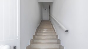 A staircase with a handrail and a door at the bottom. - Casa Sapore by BarbarHouse (San Pietro in Bevagna)