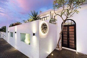 A modern villa with a white exterior, a black door, and a sign that reads 'Villa Alaiá.' - Luxury 3BR Villa w/ 2 Pools • Near Seseh Beach (Badung Regency)