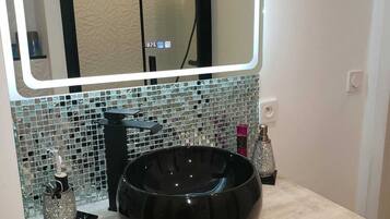 Shower, hair dryer, towels, toilet paper