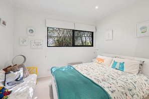 A child's bedroom with a bed, a window, and wall decorations. - Blue Datcha (Aireys Inlet)