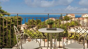 A balcony with a table and chairs, overlooking a coastal view. - Anesis - Three Bedroom Villa, Sleeps 6 (Fiskardo)