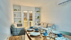 A dining area with a wooden table set for four, surrounded by chairs. - Cozy duplex apartment at the City Center (Cartagena de Indias)