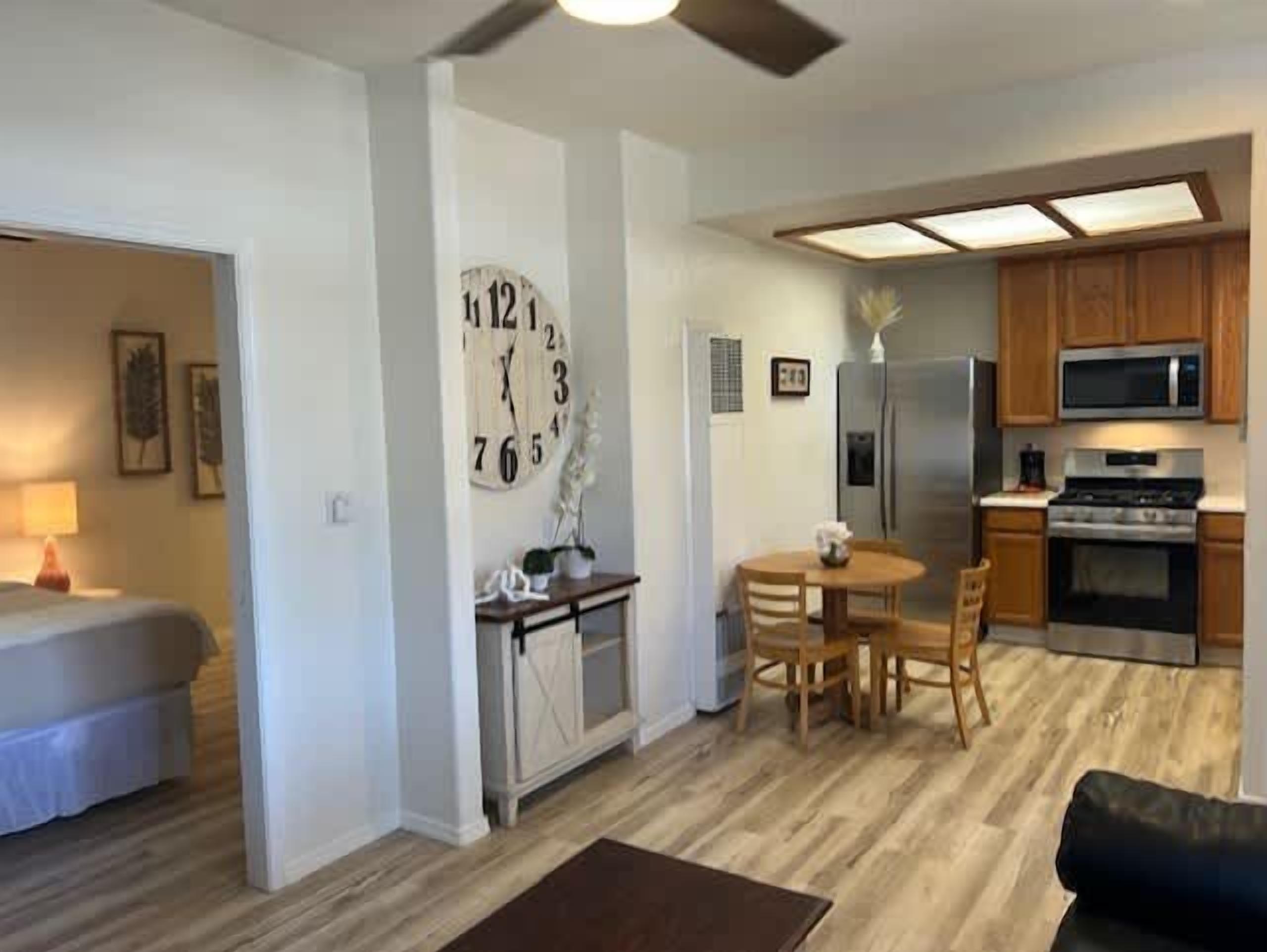 A compact living space with a kitchenette, a dining area, and a separate sleeping area.