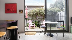 A modern kitchen with a sliding glass door leading to a patio area. - Spacious 1-bed Townhouse in Norlane (Geelong)