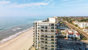 A beachfront hotel with multiple floors, balconies, and a view of the ocean. - “Sun, Sand & Spectacular Views Family-Friendly Madeira Beach Condo-Corner Unit (Madeira Beach)