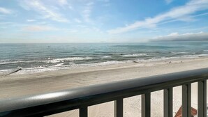 A beach view with a clear sky and calm sea. - “Sun, Sand & Spectacular Views Family-Friendly Madeira Beach Condo-Corner Unit (Madeira Beach)