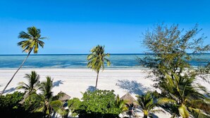 A beach with white sand and palm trees. - Matemwe Sands Beach Resort (Matemwe)