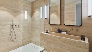 A modern bathroom with a glass-enclosed shower, a sink with a marble countertop, and two wall-mounted mirrors. - Sublim Apartment on Avenue Montaigne/eiffel Tower (Paris)