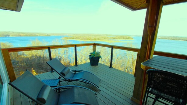 A deck with two lounge chairs and a small table, overlooking a body of water and trees. - Skytop - Hands down the best view on Beaver Lake (Rogers)
