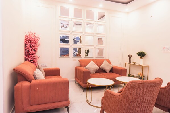 A modern living room with a sofa, armchairs, and a coffee table.