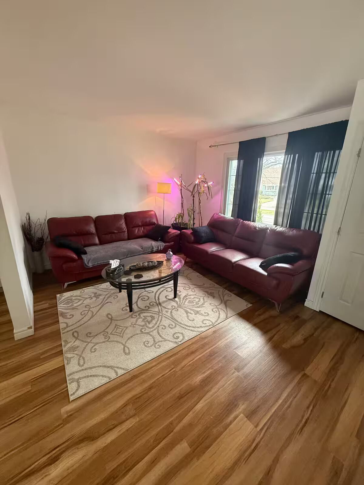 A living room with a sectional sofa, a coffee table, and a floor lamp.
