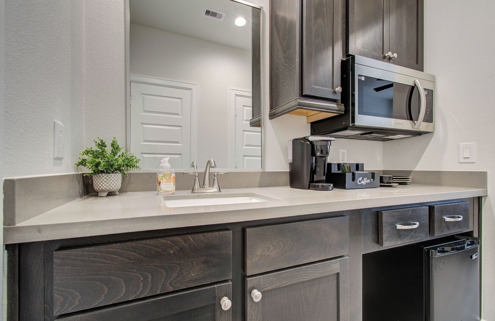 Fridge, microwave, coffee/tea maker, cookware/dishes/utensils