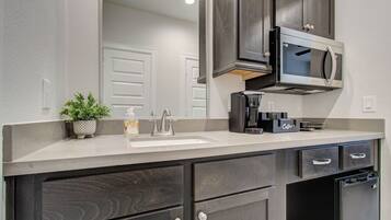 Fridge, microwave, coffee/tea maker, cookware/dishes/utensils