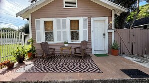 A small house with a porch, a table, two chairs, and a potted plant. - Suarez Art Stay Coconut Grove Miami Home with free Parking    (Miami)