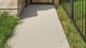A gated entrance to a building with a wooden door and a small window. - Discover the Heart of Chicago from Our Modern 3 Bed/ 2.5 Bath Home (Chicago)