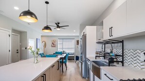 A modern kitchen with a central island, built-in appliances, and pendant lighting. - Discover the Heart of Chicago from Our Modern 3 Bed/ 2.5 Bath Home (Chicago)