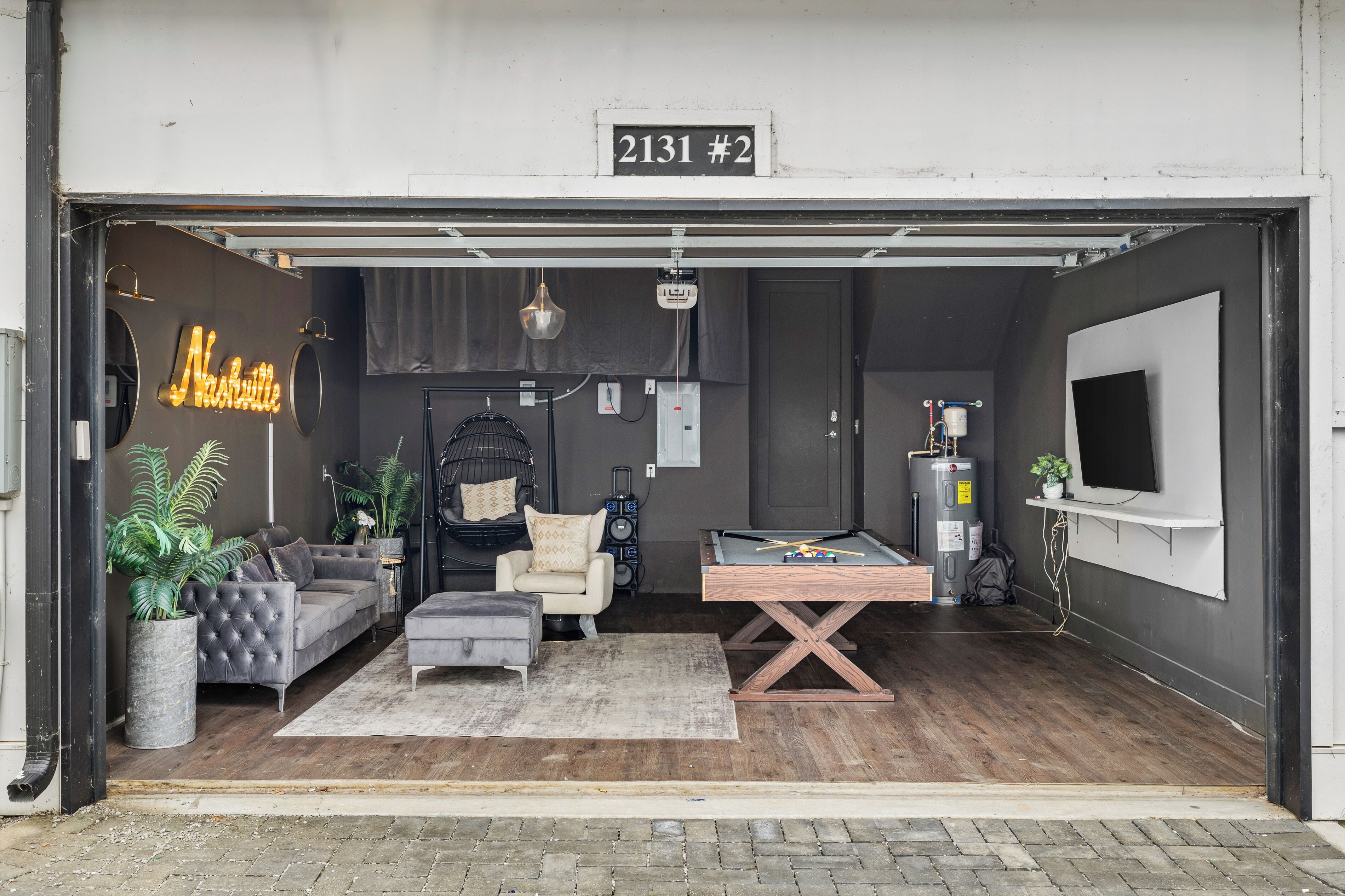 Un intérieur moderne avec un canapé, un fauteuil et une table de billard.