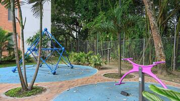 A playground with swings and a climbing structure.