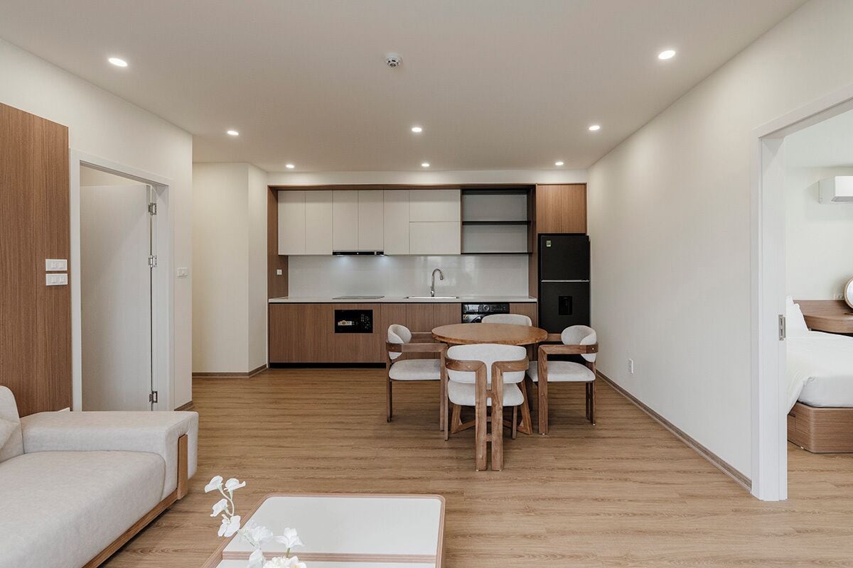 A modern apartment with a kitchen, dining area, and a living room.