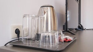A coffee maker, several glasses, and a tray on a countertop. - Hotel Razlog (Razlog)