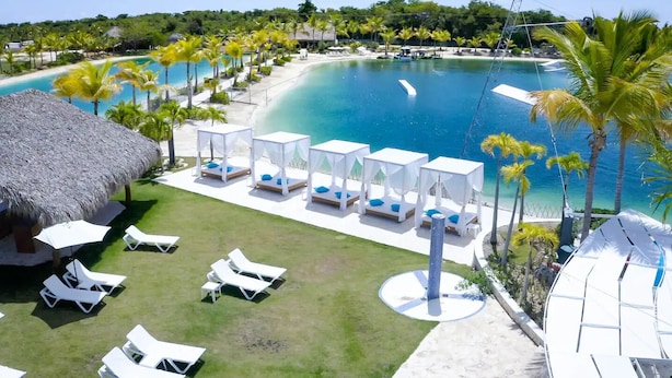 A resort with a large pool, lounge chairs, and palm trees. - Luxury private Villa with Private Pool in Vista Cana Punta Cana (Punta Cana)