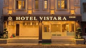 A hotel with a classic facade, arched windows, and a sign reading "HOTEL VISTARA". - Hotel Vistara (Ujjain)