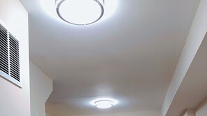 A kitchen with wooden cabinets, a refrigerator, a sink, and two bar stools. - 3BR•4 Bath•2-Min Walk to Johns Hopkins Hospital. (Baltimore)