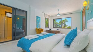 A modern bedroom with a bed, a bathroom, and a view of trees. - Swim, Sauna, Sea: An Exclusive Forest Sanctuary with Mediterranean Panoramas (antalya)