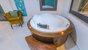 A spa area with a wooden bathtub, a yellow armchair, and a painting on the wall. - Swim, Sauna, Sea: An Exclusive Forest Sanctuary with Mediterranean Panoramas (antalya)