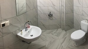 A bathroom with a sink, toilet, and shower. - Grand Aral Otel (Aksaray)
