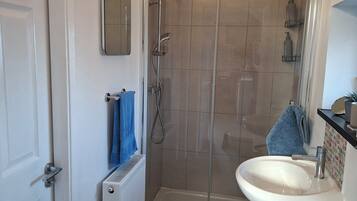 Shower, hair dryer, towels, shampoo