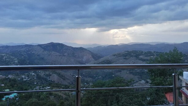 A mountainous landscape with a view of distant hills and a cloudy sky. - Ideal Holiday Destination for Families (Murree)